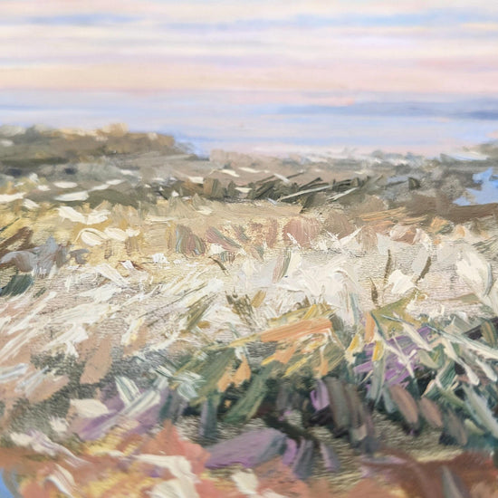 The image is an abstract painting featuring a landscape with a field of flowers and a body of water in the background.