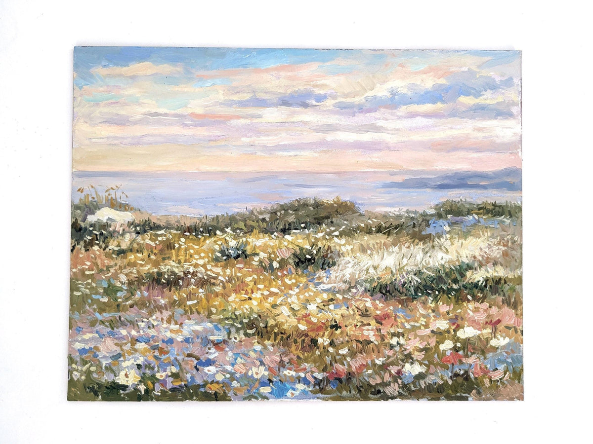 The image is an impressionist painting depicting a field of flowers with a body of water in the background.